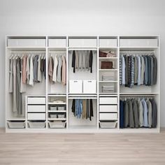 a white closet filled with lots of clothes