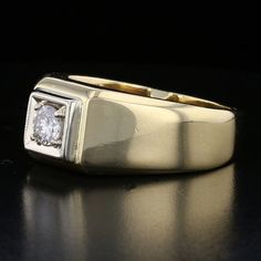 This striking vintage men's ring is a testament to timeless elegance. Crafted from 14K yellow gold, it features a round-cut diamond at its center, graded J for color, offering a subtle, classic brilliance. With a substantial weight of 13.83 grams, this piece combines luxury and durability, making it a perfect statement piece for the modern gentleman. Specifications: Metal: 14K Yellow Gold Weight: 13.83 grams Diamond: Round Cut, J Color Style: Vintage Men's Ring Size: 7.5 Classic Formal Signet Ring, Classic Signet Ring With Brilliant Cut Round Band, Classic Signet Ring With Brilliant Cut, Classic Yellow Gold Signet Ring With Single Diamond, Classic Signet Ring With Single Diamond Round Cut, Classic Diamond White Round Signet Ring, Classic Diamond White 14k Stamped Signet Ring, Classic Signet Ring With Single Diamond, Timeless Signet Ring With Single Diamond