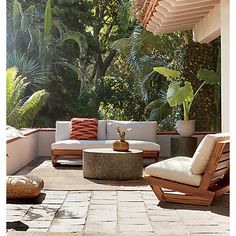 an outdoor living area with furniture and plants