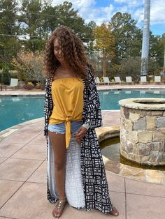 Looking for something unique and eye-catching? Check out our Danai Black Mud Print Long Sleeve Kimono! This beautiful piece is inspired by African mud prints, and is sure to turn heads wherever you go. The loose fit and long sleeves make it perfect for a variety of body types, and the ankle-length hem adds a touch of elegance. Dress it up or down, depending on your mood – either way, you're sure to look amazing! Product Details Material: 100% polyesterBelt: NoFit: loosePattern : PrintedShipping: Long Fall Vacation Tops, Black Long Sleeve Top With Boho Print, Long Casual Top For Vacation, Casual Long Tops For Vacation, Long Sleeve Tops With Abstract Print For Beach, Oversized Black Bohemian Top, Elegance Dress, Long Sleeve Kimono, Body Types