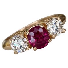 three stone gold ring with pink and white stones