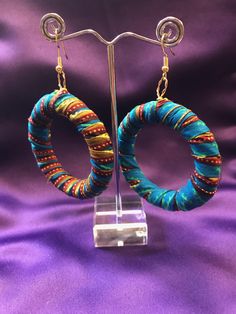 African Fabric Hoops made with wood, African Wax Print and gold plated or silver plated wires. Off cuts from our clothing collection is put to good use in these amazing African Print Hoops. Colourful African accessories add a simple flash of colour to your style. An all black outfit comes alive or your colourful African outfit gains even more with our wickedly vibrant earrings. All our jewellery qualifies for free domestic and international shipping when purchased alone.  Care-  - Fabric earring Small Hoop Earrings With Ear Wire For Festivals, Handmade Adjustable Earrings For Celebration, Hoop Earrings For Festivals, Hoop Earrings With Ear Wire For Festivals, Green Hoop Earrings For Festivals And Gifts, Bohemian Green Earrings For Celebration, Green Dangle Hoop Earrings For Celebration, Small Hoop Pierced Earrings For Festivals, Handmade Multicolor Earrings For Celebration