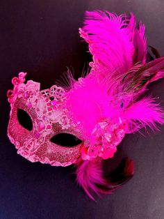 Crafted with vibrant pink hues and a touch of sparkle, this mask captures the essence of celebration and allure. Adorned with pink gems and feathers, it adds elegance to your masquerade ensemble. Captivate hearts with your radiant presence at masquerade parties, balls, galas, and more!


Age Group/Gender - Adult/Women

Size/Type - One size fits all adults

Mask Color - Pink

Mask Material - Polyresin and fabric
Special Features - Glitter and feathers Masquerade Mask Feathers, Pink Masquerade Mask, Pink Masquerade, Feather Mask, Pink Mask, Pink Gem, Masquerade Party, Masquerade Mask, Hair Clothes