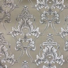 a silver and white wallpaper with an ornate design on it's side,