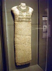 an ancient dress is on display in a glass case