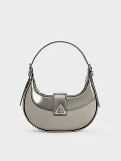 Updated for the new season, the Trice bag makes its return in a trendy metallic pewter finish -- making this the perfect party bag for nights out and festive year-end gatherings. With a clean, curved silhouette, this piece feature a belted flap detail, adorned with a distinctive triangular accent, that gives it a subtle edge. It comes with two detachable shoulder straps -- 1 short and 1 long -- offering multiple styling options. Charles And Keith Bags, Charles And Keith, Bag Stand, Bags Shop, Charles Keith, Party Bag, Metallic Accents, Perfect Party, Online Bags