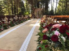 rows of chairs with flowers and greenery lining the aisle