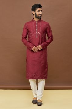 Maroon kurta with mirror work and mandarin collar. Paired with off white churidar.
Components: 2
Pattern: Embroidered
Type Of Work: Mirror
Neckline: Mandarin
Sleeve Type: Full
Fabric: Kurta: Dola Silk, Churidar: PV Cotton
Color: Maroon
Other Details: 
Mirror work
Occasion: Mehendi and Puja - Aza Fashions Traditional Slub Silk Kurta With Dabka Work, Festive Chanderi Kurta With Zari Work, Semi-stitched Chanderi Sherwani With Cutdana, Festive Slub Silk Kurta With Traditional Drape, Designer Slub Silk Kurta For Festivals, Festival Kurta In Slub Silk With Dabka Work, Festive Chanderi Kurta With Dabka Work, Designer Kurta With Gota Work For Navratri, Bollywood Style Slub Silk Kurta With Gota Work