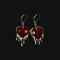 Handmade earrings with brilliant red crystal hearts and soft solder details. Inspired by the heavily encased jewels in metalwork of the Middle Ages, these reference the motif of the bleeding heart, and popular jewelry styles of the period. Hypoallergenic silver plated french earring hooks Made to order; will be unique and vary from product photo Metal Heart Cut Earrings As Gift, Heart Cut Metal Earrings For Gift, Metal Jewelry With Heart Charm For Party, Metal Heart Charm Jewelry For Party, Metal Crystal Earrings For Valentine's Day Gift, Red Drop Earrings For Valentine's Day, Gothic Heart Pendant Metal Jewelry, Party Ruby Earrings In Silver, Party Ruby Silver Earrings