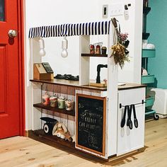 the small kitchen is decorated with black and white striped decor on it's walls