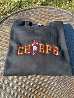 Chiefs Kelce Embroidered Crewneck Sweatshirt Black Crew Neck Top With Letter Embroidery, Crew Neck Top With Embroidered Text For College, Fall College Embroidered Tops, Embroidered Fall Tops For College, Embroidered Long Sleeve Tops For College, Fall College Embroidered T-shirt, Black Crew Top With Custom Embroidery, Black Custom Embroidered Tops For College, Black Crew Neck Top With Custom Embroidery