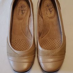 Beige Slip On Flats. Insoles Are Very Cushiony. Man Made Materials. Beige Flats With Arch Support And Round Toe, Beige Flats With Ortholite Insole, Medium Width, Beige Flats With Arch Support, Beige Closed Toe Flats With Arch Support, Beige Cushioned Low-top Flats, Beige Low-top Cushioned Flats, Comfortable Round Toe Heels With Cushioned Footbed, Comfortable Cushioned Round Toe Heels, Spring Low-top Flats With Ortholite Insole