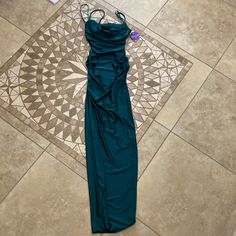 a green dress laying on the floor