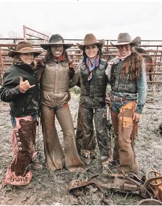 three women standing next to each other in cowboy gear