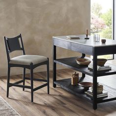 a table with two chairs next to it and a shelf on the floor in front