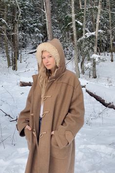 "Warm and cozy 60's - 70's hooded wool blanket coat with pockets and braided rope + wooden toggle buttons. Big and heavy, sure to keep you warm!! This coat is in good vintage condition - there are a few small little moth bites. Sizing + Measurements: Fits like a women's XL - XXL / Oversized Bust: 58\" Sleeve: 25\" Shoulders: 20\" Overall Length: 39\" For reference, model is 5'9\" 34/29/40 All measurements are taken flat and then doubled when appropriate. Please let us know if you have any questi Wool Hooded Jacket For Cold Weather In Fall, Cozy Wool Outerwear With Buttons, Brown Parka With Adjustable Hood For Cold Weather, Wool Hooded Outerwear For Outdoor, Hooded Wool Outerwear For Outdoor, Hooded Pea Coat For Winter, Brown Hooded Parka For Cold Weather, Wool Hooded Jacket For Winter, Hooded Wool Outerwear With Pockets