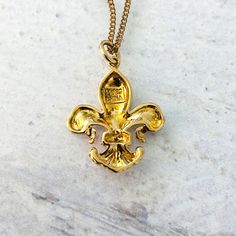 A lovely fleur de lis gold vermeil diamond pendant necklace, very detailed and nicely rendered. This is such a beautiful representation of the fleur de lis! Made of gold vermeil (gold over sterling silver), and is set with a band of tiny diamonds. The pendant measures a bit over 1 inch, including the ring on top. It is 3/4 of an inch at the widest point. The curb chain is 18 inches long, making it ideal for layering. The pendant is marked 925, China, and R for the maker, which is for Ross Simmon Tiny Diamond, The Maker, Diamond Pendant Necklace, Curb Chain, Vintage Charms, Diamond Pendant, Gold Vermeil, 1 Inch, Layering