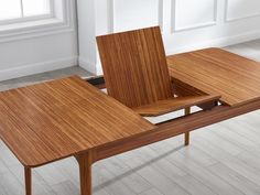 a wooden table sitting on top of a hard wood floor