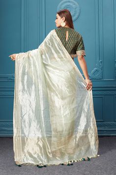 Look royal on weddings and festive occasions in this alluring pista green tissue Kora silk saree. It comes with a beautiful dark green printed and embroidered saree blouse. Green Chanderi Blouse With Sheer Dupatta, Pista Green Cotton Silk Blouse Piece For Wedding, Pista Green Chanderi Blouse With Dupatta, Wedding Blouse Piece In Pista Green Cotton Silk, Green Tissue Silk Blouse With Dupatta, Green Cotton Silk Blouse With Dupatta, Transitional Pista Green Chanderi Blouse Piece, Pista Green Chanderi Blouse With Traditional Drape, Designer Pista Green Cotton Silk Blouse Piece