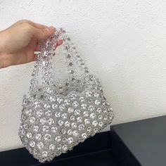 The Eva Diamonds Handbag exudes elegance and sophistication, featuring large rhinestones carefully arranged against a beautifully beaded exterior. Its comfortable handle ensures easy carrying, while the spacious interior accommodates all your essentials with style and grace. Perfect for matching with a variety of outfits, this bag seamlessly transitions from day to night, adding a touch of sparkle to any ensemble. Exclusively available in white. Chic Embellished Crystal Bag, Chic Embellished Crystal Evening Bag, Glamorous Everyday Use Tote Bag, Top Handle Shoulder Bag With Rhinestones For Everyday, Chic Silver Bags With Rhinestones, Chic Handheld Evening Bag With Rhinestones, Chic Handheld Shoulder Bag With Rhinestones, Elegant Rhinestone Tote Shoulder Bag, Elegant Rhinestone Tote Bag