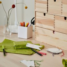 the desk is cluttered with pens, markers and other office supplies on top of it