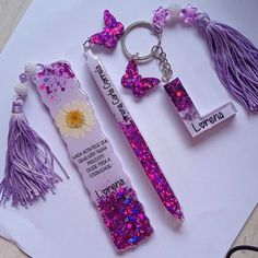 three different types of keychains with tassels and beads on them sitting on top of a piece of paper