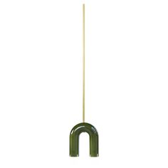 a green object with a wooden stick sticking out of it's center on a white background