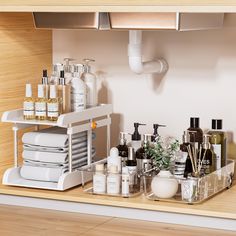 a kitchen counter with dishes, soaps and lotion bottles on the top shelf