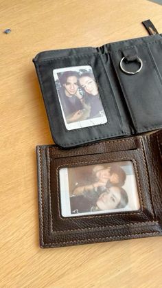 an open wallet with two pictures on it