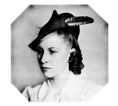 an old black and white photo of a woman wearing a hat with feathers on it