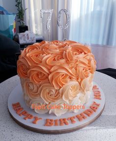 an orange and white cake with the number 70 on it