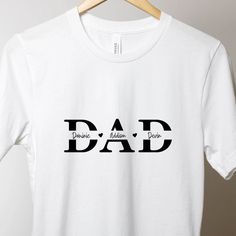 This adorable t-shirt is perfect for all the amazing dads out there. Whether you're looking for a thoughtful gift or just want to show appreciation for the special man in your life, this t-shirt is a wonderful choice. Available in black, gray, or white, this t-shirt can be customized with all your children’s names, making it truly unique and special. Made from 100% pre-shrunk cotton and featuring high quality, soft flex vinyl, the graphic on this t-shirt is sharp and vivid, ensuring it always lo Father's Day Family Text Print T-shirt, Father's Day T-shirt With Funny Text In Relaxed Fit, Father's Day Name Print Crew Neck T-shirt, Father's Day T-shirt With Funny Text And Crew Neck, Personalized White T-shirt For Father's Day, Father's Day Funny Text Crew Neck T-shirt, Funny White T-shirt For Father's Day, Personalized T-shirt For Father's Day, Father's Day Family Matching T-shirt With Funny Text