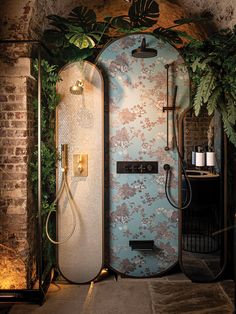 the shower is surrounded by greenery and wallpaper, with an open door leading to it