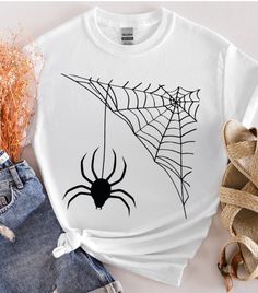 About this item Spider web t-shirt, Halloween shirt, customer t-shirt, Happy Halloween , designer shirt, desıgn gift, funny  special shirt, spooky season, Gildan unisex t-shirts We make design t-shirts, sweatshirts and hoodies that you can use at every special moment of your life and give as a gift to you and your loved ones... We are looking forward to adding color to your life... *  We use the Gildan Soft Style brand.  ---How To Order --- * Please, check and review all photos * Choose your t-s Halloween Graphic Print Top As Gift, Casual Halloween T-shirt For Gift, Spooky Custom Print Halloween T-shirt, Casual Halloween Tops For Gifts, Halloween Spooky Sublimation Print T-shirt, Halloween White T-shirt With Sublimation Print, Spooky White T-shirt With Custom Print, White Halloween T-shirt With Sublimation Print, Short Sleeve Halloween Top As Gift