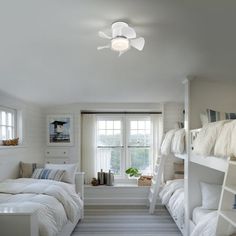 a bedroom with bunk beds and white walls