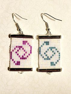 two square shaped beaded earrings with cross stitched designs on the front and back