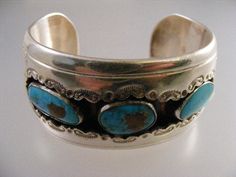 "Lovely vintage Signed Native American Turquoise Shadowbox Cuff Bracelet in Sterling Silver. Bracelet 1.29\" (32.9mm) wide. Turquoise stones measure 10x19mm, 12x16mm, and 9.5x20mm. Interior of bracelet measures 5 1/8\", with an additional 1 1/8\" opening gap, for a total of 6 1/4\". This cuff is not sizable. Bracelet has a nice weight of 67.5 grams. Signed GD as can be seen in photo #5. Tests positive for sterling. In very good pre-owned condition." Native American Turquoise, American Turquoise, Turquoise Stones, Sterling Silver Bracelet, Turquoise Stone, Vintage Signs, Shadow Box, Cuff Bracelet, Nativity