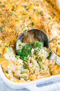 broccoli and rice casserole in a white dish with a spoon