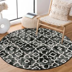 a black and white area rug in a living room with a chair, vase and window