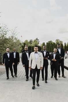 a group of men in tuxedos standing next to each other