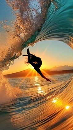 a person riding a wave on top of a surfboard in the ocean at sunset