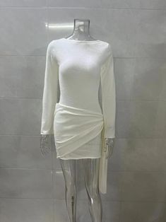 a mannequin with a white dress on display