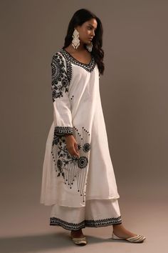 White kurta with floral, beads hand embroidery. Paired with palazzo.
Components: 2
Pattern: Embroidered
Type Of Work: Floral
Neckline: V neck
Sleeve Type: Oversized
Fabric: Summer Silk
Color: Black
Other Details: 
Cutwork border
Attached lining
Length:
Kurta: 46 inches
Palazzo: 38 inches
Occasion: White - Aza Fashions Bohemian Straight Kurta Set With Floral Embroidery, Bohemian Set With Straight Kurta And Floral Embroidery, Traditional Embroidered Dress With Mirror Work For Designer Wear, Bohemian Sets With Straight Kurta And Floral Embroidery, Bohemian Sets With Floral Embroidery On Straight Kurta, Navratri Palazzo Set With Intricate Embroidery, Embroidered Mulmul Palazzo Set For Wedding, Bohemian Palazzo Set With Mirror Work For Diwali, Navratri Resham Embroidery Straight Kurta