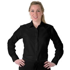 a woman is standing with her hands on her hips wearing a black shirt and pants