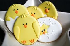 three decorated cookies in the shape of chicks