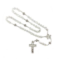 Clear glass cubes rosary, with silver-plated accents and an ornate crucifix,  perfect for weddings, first communions, baptisms, and other special occasions. White Spiritual Cross Jewelry And Charms, Elegant Silver Rosary Bracelet For Baptism, Silver Crucifix For Wedding, Elegant Silver Rosary As Gift, Silver Miraculous Medal For Wedding, Silver Miraculous Medal Jewelry For Wedding, Silver Cross Rosary As Gift, White Crucifix Rosary With Miraculous Medal, Silver Spiritual Jewelry For First Communion