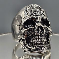 a silver ring with a skull on it