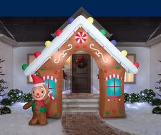 an inflatable christmas house is decorated with gingerbreads and candy canes