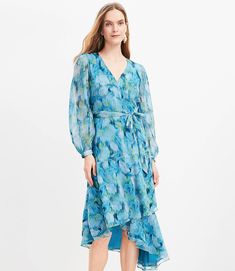 Shimmer Floral Ikat Ruffle Wrap Dress Spring V-neck Dress With Layered Hem, Elegant Flowy Tiered V-neck Dress, Elegant Flowy V-neck Tiered Dress, Spring Chiffon Dress With Tie Waist, Chic Flowy Tiered Dress With Floral Print, Chic Blue Tiered Dress, Spring Chiffon Midi Dress With Tiered Skirt, Chic Flowy V-neck Tiered Dress, Flowy Spring Ruffle Dress With Layered Hem