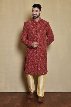 Red full sleeve sherwani with mirror, thread, cutdana, sequin embroidery in chevron pattern. Paired with gold pant. - Aza Fashions Red Sherwani For Festive Occasions, Red Long Sleeve Sherwani With Resham Embroidery, Navratri Long Sleeve Sherwani With Mirror Work, Long Sleeve Sherwani With Mirror Work For Navratri, Red Fitted Sherwani For Navratri, Festival Long Sleeve Sherwani With Gota Work, Ceremonial Sherwani With Gota Work And Long Sleeves, Ceremonial Long Sleeve Sherwani With Gota Work, Long Sleeve Sherwani With Gota Work For Ceremonial Occasions